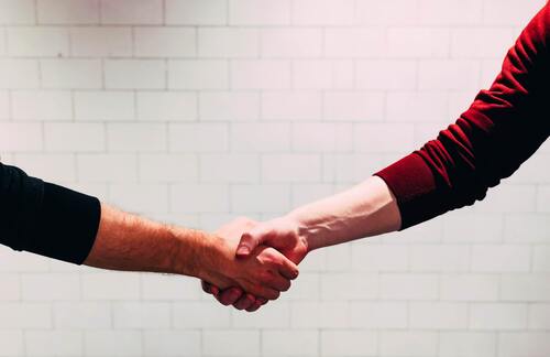 Two hands engaged in a firm handshake | Jacko Law Group, PC