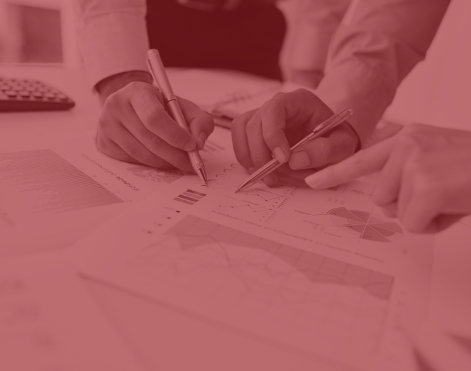 Two hands holding pens collaborate over financial charts | Jacko Law Group, PC