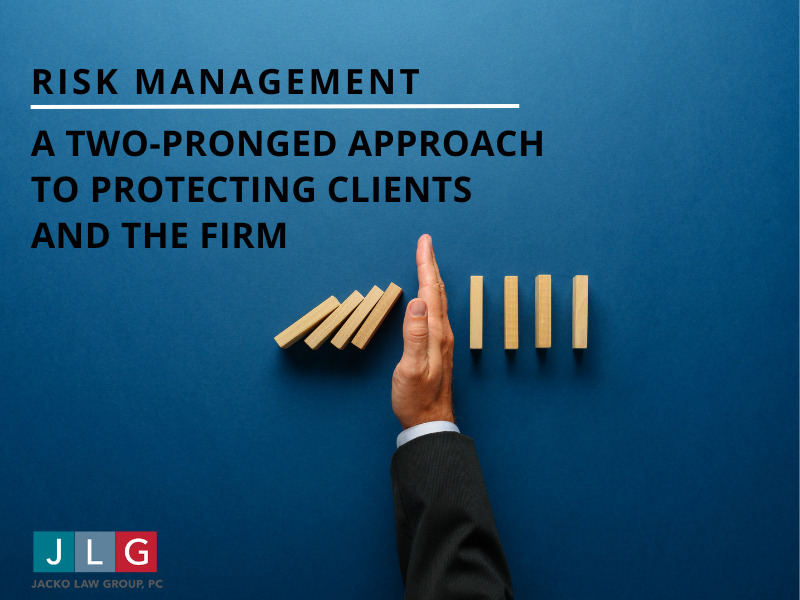 A hand halting wooden blocks on a blue background | Jacko Law Group, PC