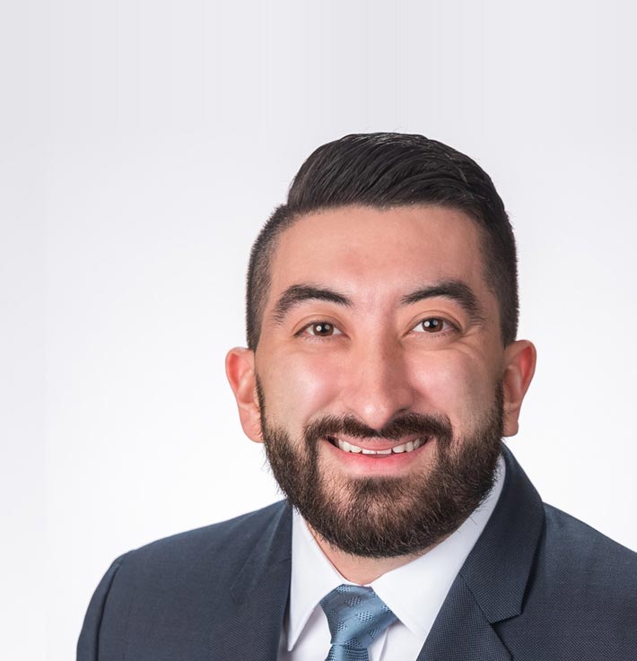 A bearded man in a tie smiles warmly | Jacko Law Group, PC