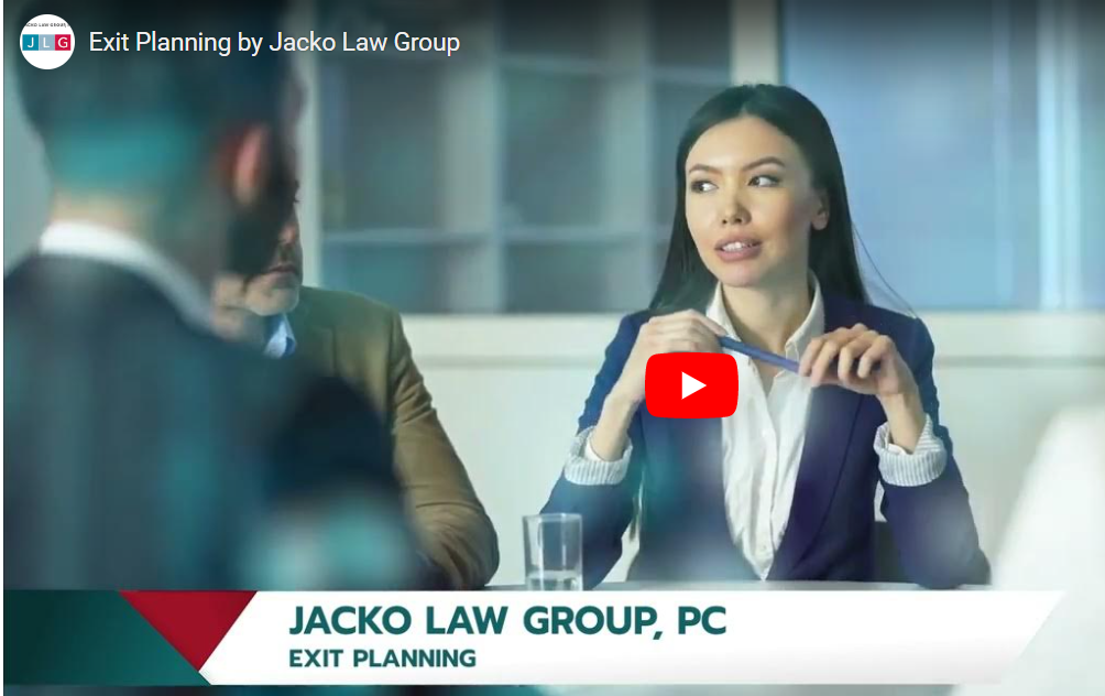 A business meeting in a bright room, focusing on a woman | Jacko Law Group, PC