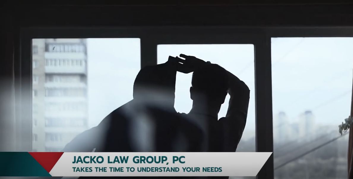 Silhouettes of two individuals standing near a window | Jacko Law Group, PC