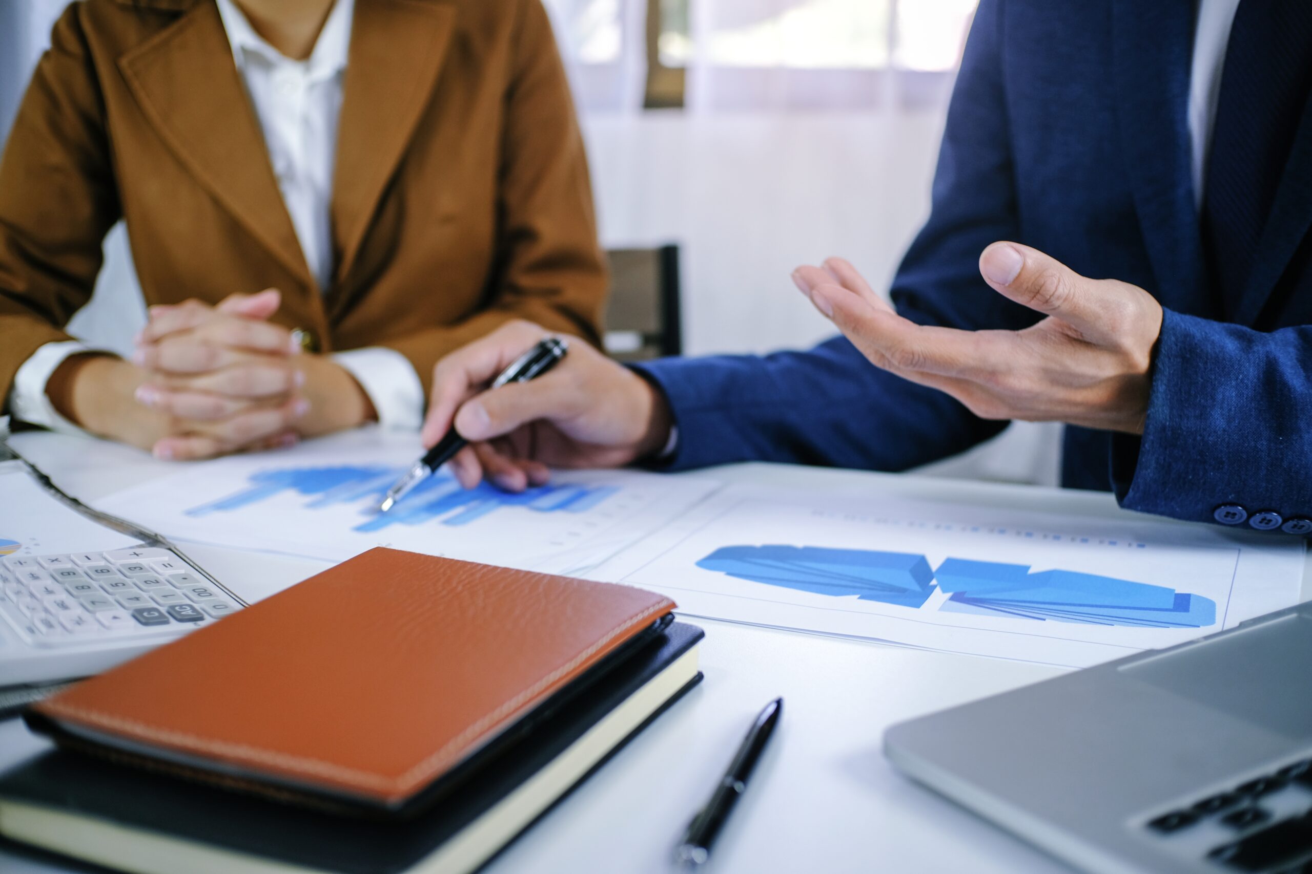 Two professionals engaged in a discussion at a table | Jacko Law Group, PC