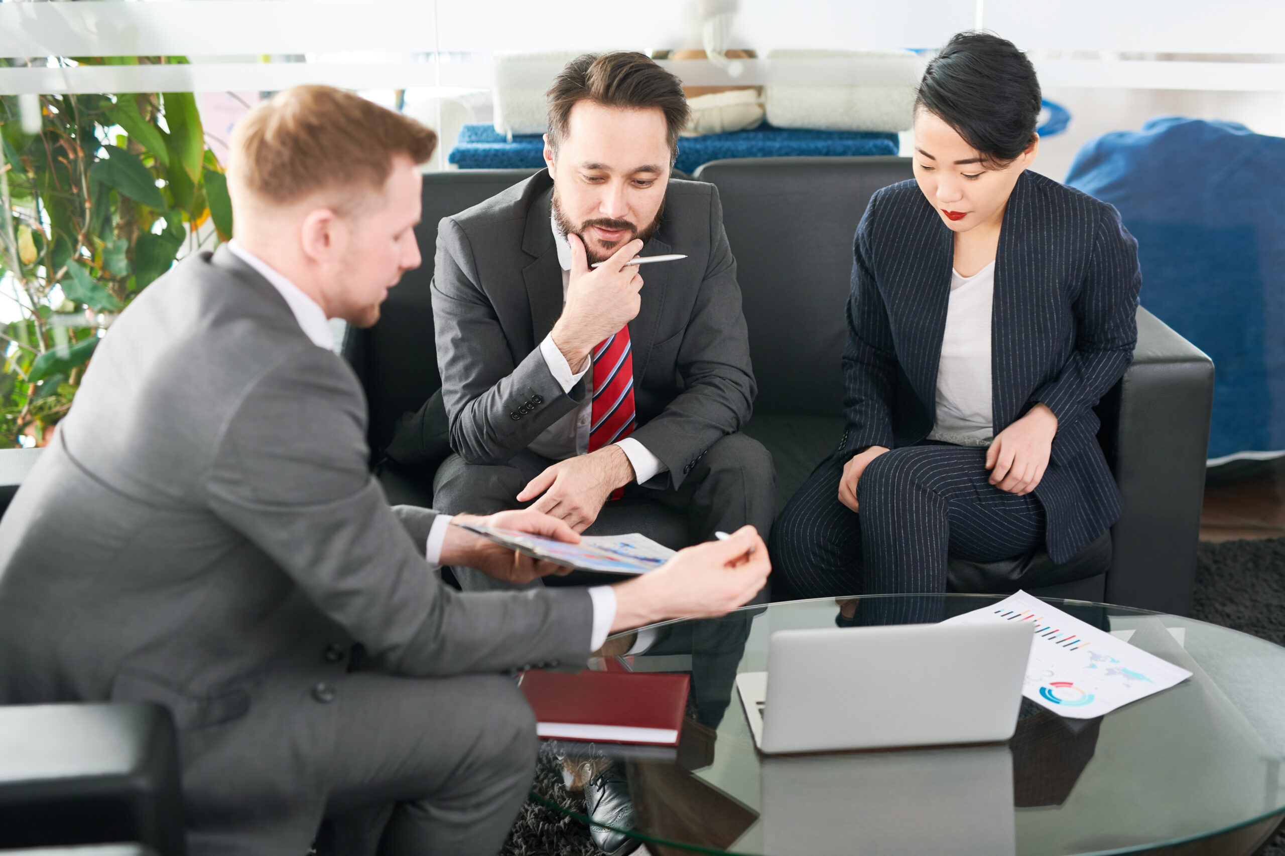 Three business professionals engaged in a meeting | Jacko Law Group, PC