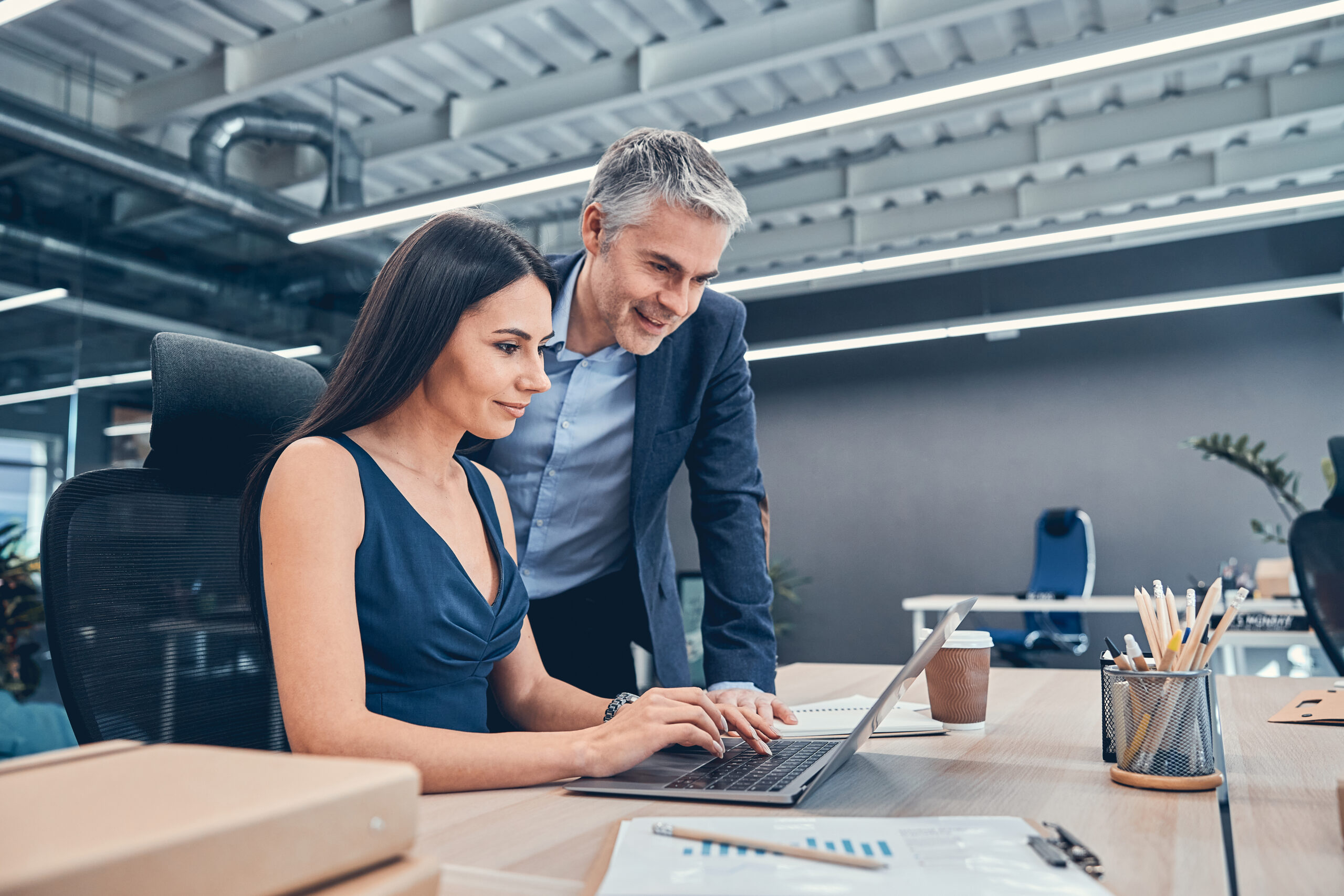 Two professionals collaborate at a modern office desk | Jacko Law Group, PC