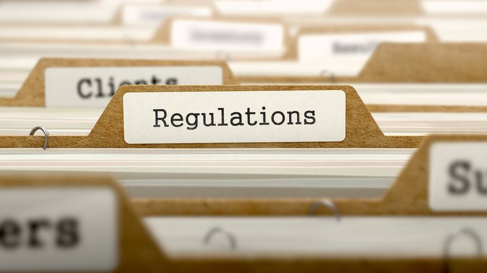 Close-up of a file folder labeled Regulations | Jacko Law Group, PC