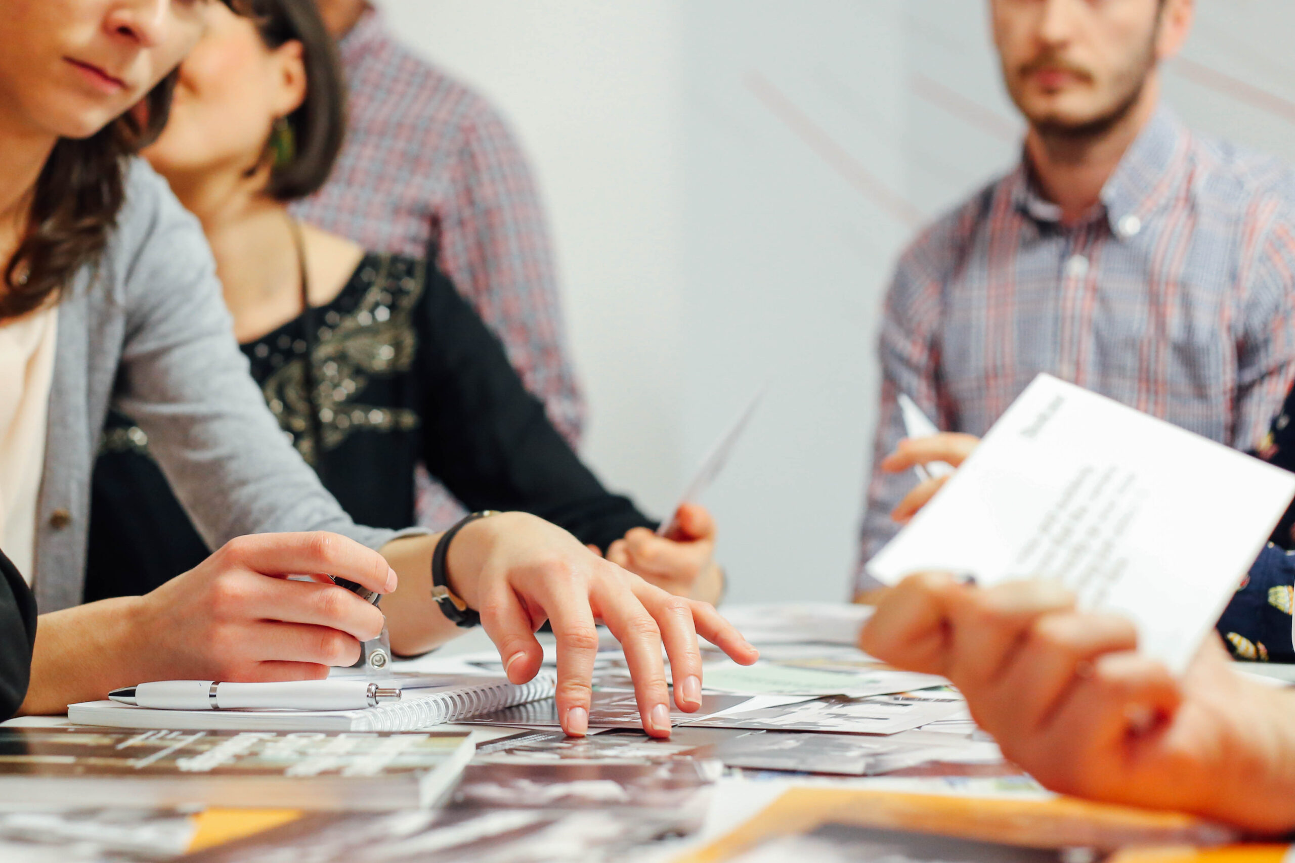 A group of people collaborating at a table | Jacko Law Group, PC