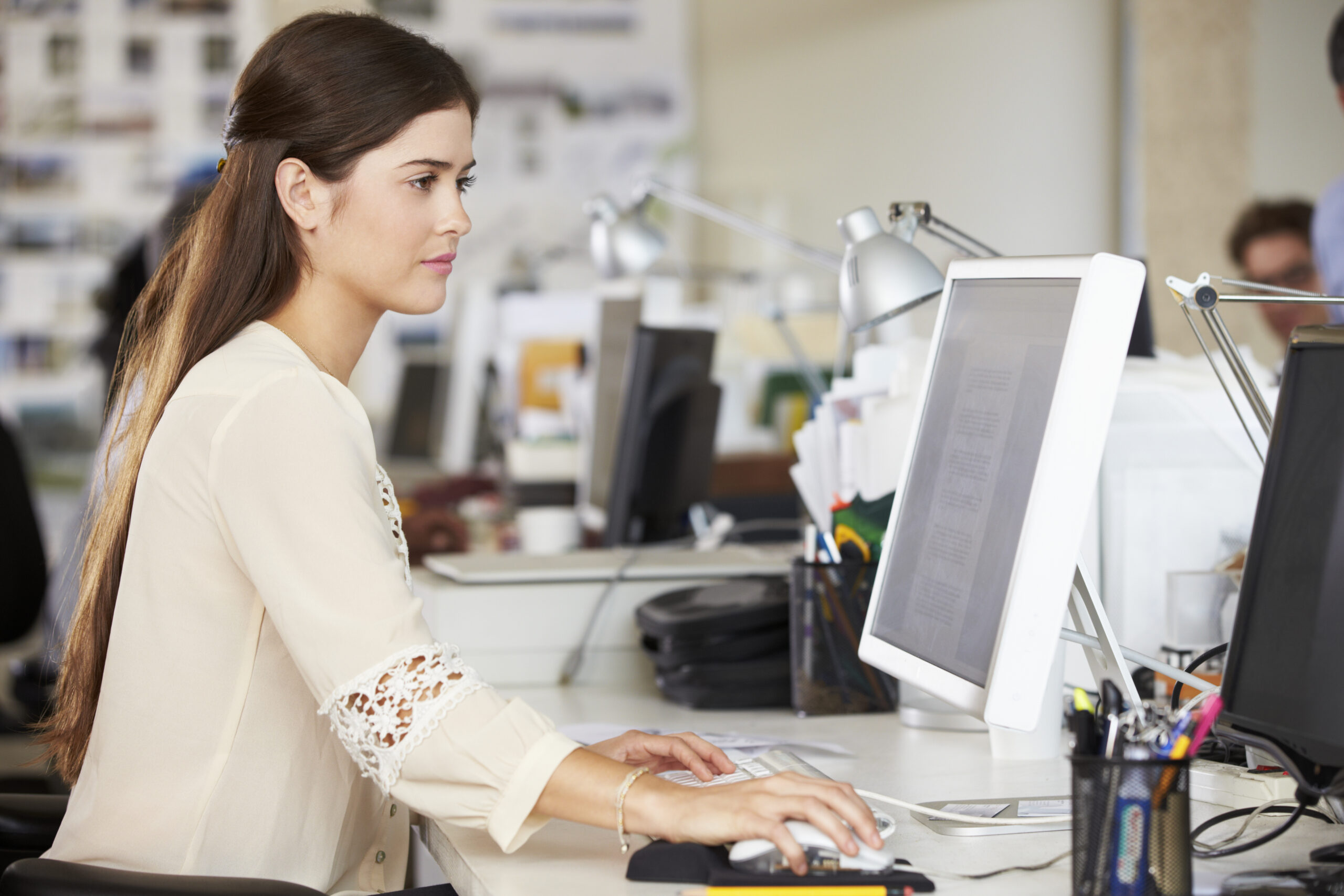 A woman working diligently at her desk | Jacko Law Group, PC