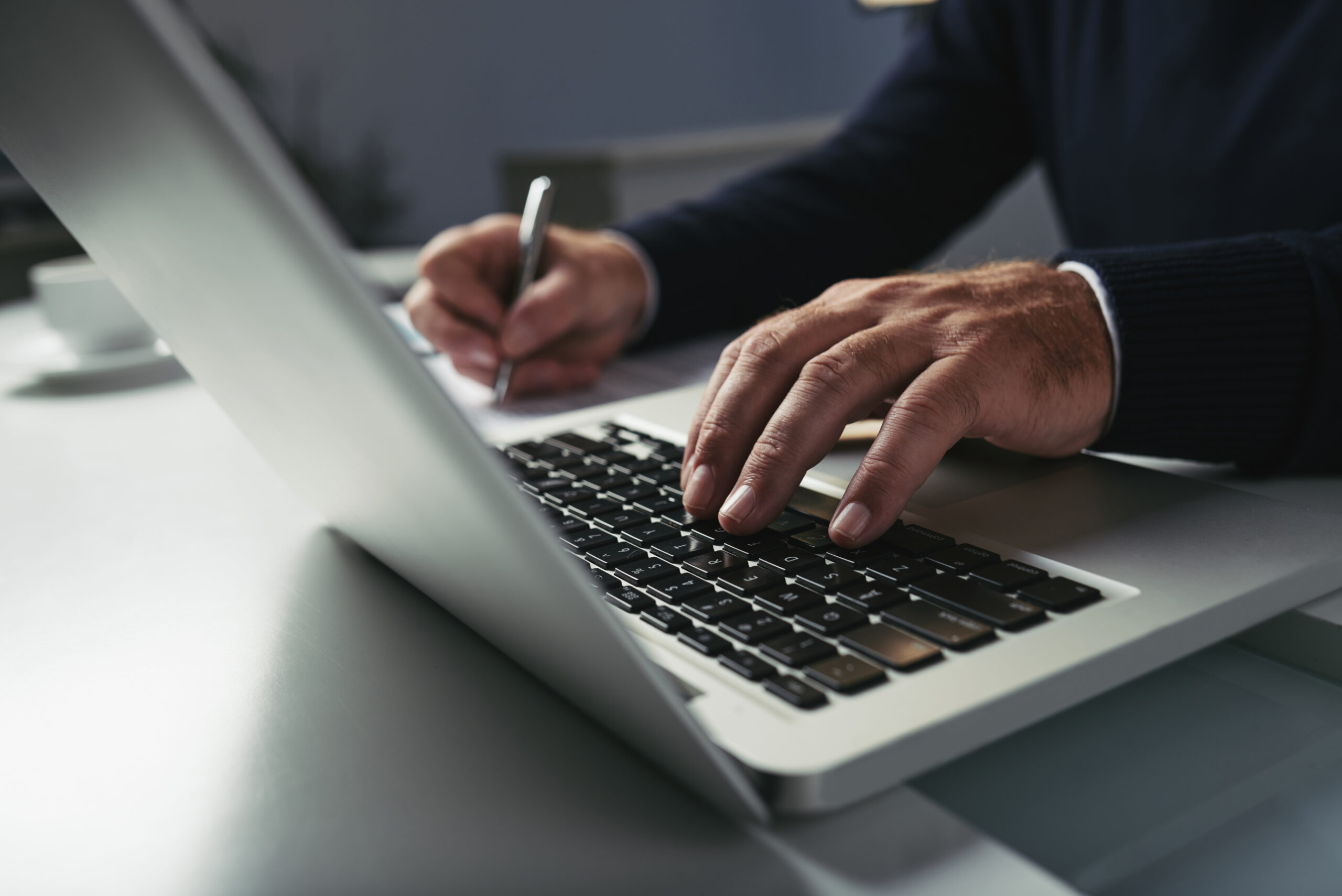 A close-up of a person's hands typing on a laptop keyboard | Jacko Law Group, PC